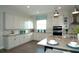 Modern kitchen with white cabinetry, stainless steel appliances, and a center island with seating at 9558 Brave Buck Ave, Land O Lakes, FL 34638