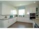 Well-lit kitchen featuring sleek countertops, stainless steel appliances, and ample white cabinetry at 9558 Brave Buck Ave, Land O Lakes, FL 34638