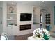 Cozy living room with built-in shelves, modern fireplace, and stylish accents for comfortable relaxation at 9558 Brave Buck Ave, Land O Lakes, FL 34638