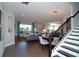 Bright open-concept living area with staircase, connecting living, dining, and kitchen spaces for modern living at 9558 Brave Buck Ave, Land O Lakes, FL 34638