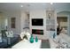 Living room with fireplace, built-in shelving, and view into a bedroom, offering cozy relaxation and style at 9558 Brave Buck Ave, Land O Lakes, FL 34638