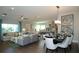 Open-concept living space with dining area and kitchen, featuring hardwood floors and stylish, coordinated decor at 9558 Brave Buck Ave, Land O Lakes, FL 34638