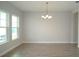 Dining room featuring neutral walls, chandelier, windows, and tiled flooring at 9572 Brave Buck Ave, Land O Lakes, FL 34638