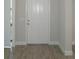 Entryway featuring a white front door, neutral colored walls and tiled flooring at 9572 Brave Buck Ave, Land O Lakes, FL 34638