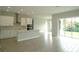 A bright, open kitchen with modern appliances, a center island, and sliding doors to the backyard at 9572 Brave Buck Ave, Land O Lakes, FL 34638