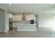 Modern kitchen features stainless steel appliances, white cabinets, and a central island with a sink at 9572 Brave Buck Ave, Land O Lakes, FL 34638