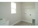 Clean laundry room with a sink, utility connections, and tiled flooring at 9572 Brave Buck Ave, Land O Lakes, FL 34638
