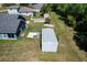 Aerial view of property with steel shed, home, backyard, and grass at 3708 Alafia Creek St, Plant City, FL 33567