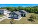 Aerial view of a well-maintained home and lawn, showcasing the spacious yard and neighboring houses at 3708 Alafia Creek St, Plant City, FL 33567