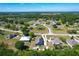 Scenic aerial captures this home within a community, showing the surrounding trees and a pond at 3708 Alafia Creek St, Plant City, FL 33567