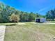 Wide backyard featuring the metal shed, and a seating area with a concrete patio at 3708 Alafia Creek St, Plant City, FL 33567