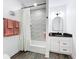Modern bathroom with textured tile shower, black fixtures, and a vanity with a dark countertop at 3708 Alafia Creek St, Plant City, FL 33567