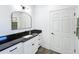 Bathroom with white cabinets, black countertop, modern fixtures, and neutral tones at 3708 Alafia Creek St, Plant City, FL 33567