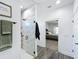 Modern bathroom featuring tiled shower with glass door, and adjoins a bedroom with carpeted floor at 3708 Alafia Creek St, Plant City, FL 33567