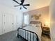 Cozy bedroom with a metal frame bed, stylish decor, carpet, and natural light at 3708 Alafia Creek St, Plant City, FL 33567