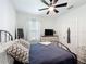 Well-lit bedroom featuring a ceiling fan, a dresser with a TV, and a comfortable bed with throw pillows at 3708 Alafia Creek St, Plant City, FL 33567