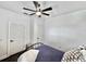 Bright bedroom featuring a ceiling fan, two white doors, and dark wood floors at 3708 Alafia Creek St, Plant City, FL 33567