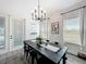 Bright dining room with stylish chandelier, large windows, and elegant black dining set at 3708 Alafia Creek St, Plant City, FL 33567