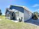 Back exterior view of home, showcasing the back patio and lush, green yard, perfect for entertaining at 3708 Alafia Creek St, Plant City, FL 33567