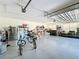 Spacious garage for storage and parking, features an automatic garage door and epoxy flooring at 3708 Alafia Creek St, Plant City, FL 33567