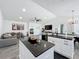 Open-concept kitchen and living room with modern fixtures, neutral tones, and ample natural light at 3708 Alafia Creek St, Plant City, FL 33567