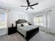 Main bedroom featuring large windows with flowing curtains, ceiling fan and neutral colored walls at 3708 Alafia Creek St, Plant City, FL 33567