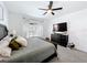 Spacious bedroom with carpet flooring, ceiling fan, and a large dresser under the television at 3708 Alafia Creek St, Plant City, FL 33567
