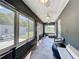 Relaxing enclosed patio with tile flooring, three ceiling fans and backyard views through multiple windows at 3708 Alafia Creek St, Plant City, FL 33567