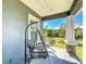 Relaxing porch view with hanging porch swings, stone pillar accents, and outdoor comfort at 3708 Alafia Creek St, Plant City, FL 33567