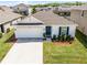 Inviting single-story home with a manicured lawn in a Gathering-friendly neighborhood with mature landscaping at 38370 Sonnet Landing Ave, Zephyrhills, FL 33540