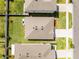 Aerial view of the house with its well-maintained lawn, roof, and neighborhood layout at 38370 Sonnet Landing Ave, Zephyrhills, FL 33540