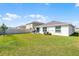 A spacious, well-maintained backyard featuring lush green grass and a privacy fence at 38370 Sonnet Landing Ave, Zephyrhills, FL 33540