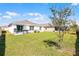 The large grassy backyard features a patio and privacy fence, perfect for outdoor entertaining at 38370 Sonnet Landing Ave, Zephyrhills, FL 33540