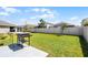 Expansive backyard with a grill, patio area and privacy fence; great for outdoor enjoyment at 38370 Sonnet Landing Ave, Zephyrhills, FL 33540