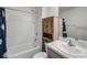 Bright bathroom featuring a shower-tub, vanity with countertop, and wooden cabinet for ample storage at 38370 Sonnet Landing Ave, Zephyrhills, FL 33540