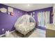 Adorable ' bedroom with unique princess-themed carriage bed frame and purple walls at 38370 Sonnet Landing Ave, Zephyrhills, FL 33540