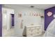 A view of a ' bedroom with princess-themed decor and a bright purple accent wall at 38370 Sonnet Landing Ave, Zephyrhills, FL 33540