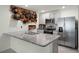 Modern kitchen featuring stainless steel appliances, light gray cabinetry, and a stylish granite countertop at 38370 Sonnet Landing Ave, Zephyrhills, FL 33540