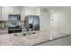 Bright kitchen features stainless steel appliances, granite countertops, and ample cabinet space at 38370 Sonnet Landing Ave, Zephyrhills, FL 33540