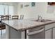 Kitchen with a double stainless sink and granite countertop looking out on the dining area at 38370 Sonnet Landing Ave, Zephyrhills, FL 33540
