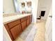 Bathroom with wooden cabinets, neutral countertops, and a decorative rug at 6698 Wirevine Dr, Brooksville, FL 34602