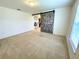 Bedroom featuring a decorative barn door with carpet flooring and bright natural light at 6698 Wirevine Dr, Brooksville, FL 34602