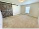 Bedroom with carpet flooring, a window, and a decorative barn door at 6698 Wirevine Dr, Brooksville, FL 34602