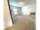 A bright, carpeted bedroom with a window and neutral color palette at 6698 Wirevine Dr, Brooksville, FL 34602
