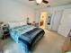 Bedroom featuring a bed with carpet flooring, a ceiling fan and multiple interior entryways at 6698 Wirevine Dr, Brooksville, FL 34602