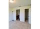 Bedroom featuring neutral carpet with an ensuite bathroom and closet at 6698 Wirevine Dr, Brooksville, FL 34602
