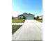 Charming one-story home featuring a well-manicured lawn and long driveway at 6698 Wirevine Dr, Brooksville, FL 34602