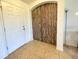 Foyer with light tile flooring, a white door and a decorative wooden arched panel at 6698 Wirevine Dr, Brooksville, FL 34602