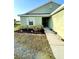 This home's front yard is landscaped with bushes and mulch. The house is painted a neutral green color at 6698 Wirevine Dr, Brooksville, FL 34602