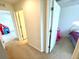 Hallway with doorways leading to bedrooms with carpet flooring at 6698 Wirevine Dr, Brooksville, FL 34602